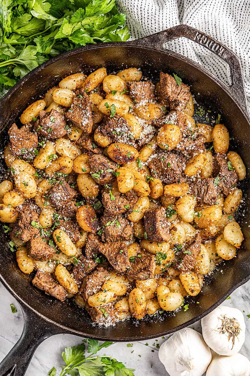 Overhead view of steak bites and gnocchi.