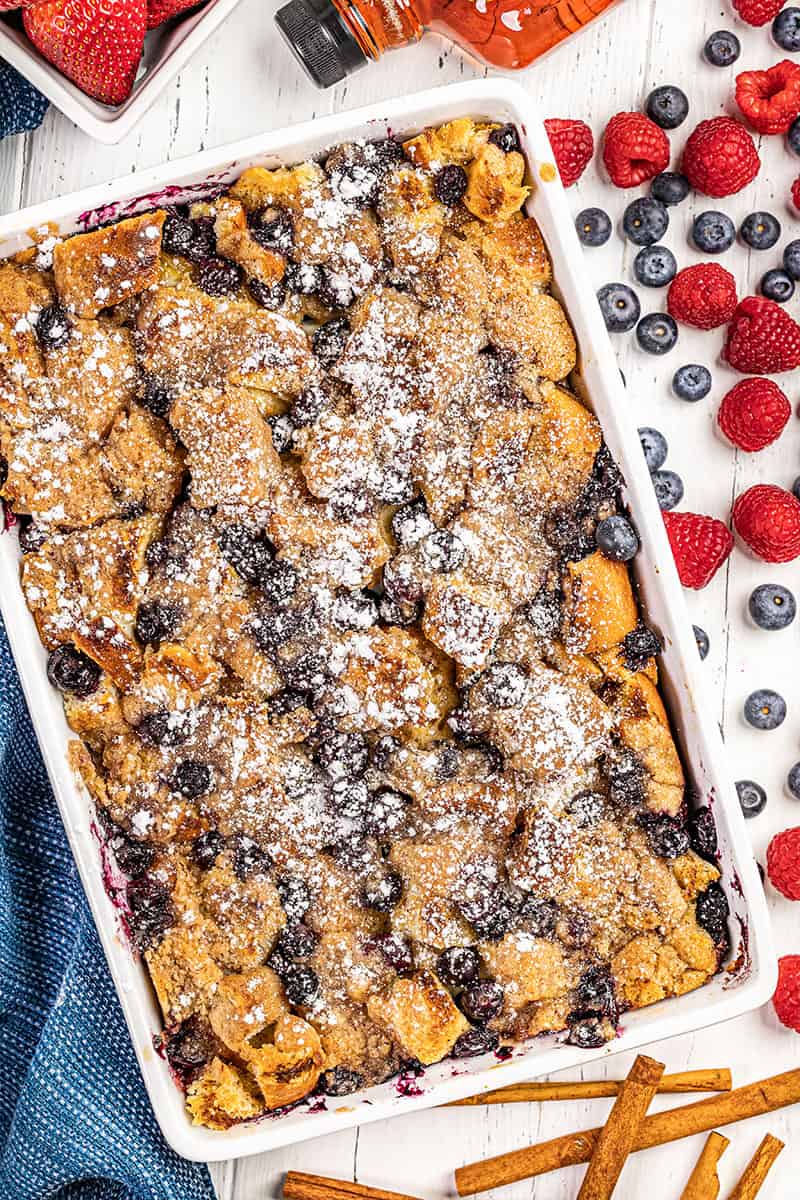 Overhead view of a French toast casserole in a white baking dish.