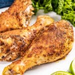 Easy baked chicken drumsticks on a dinner plate.