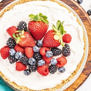 Overhead view of a no bake cheesecake with berries on top.