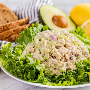 Tuna salad on a plate of lettuce.