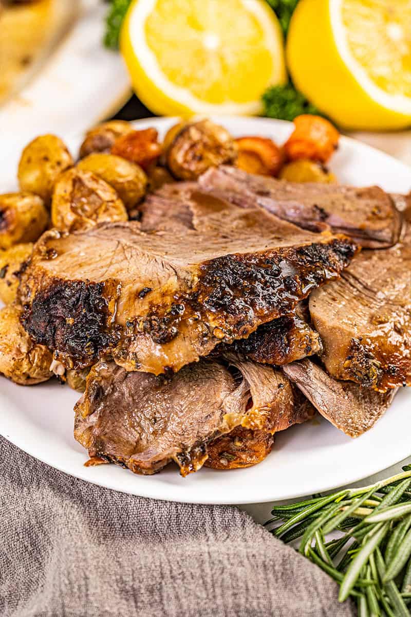 Close up view of a roasted leg of lamb, carved.