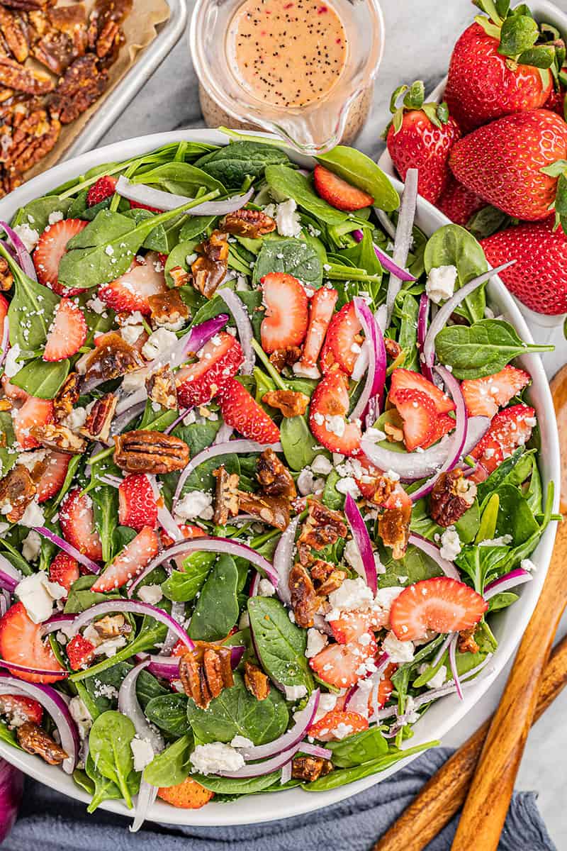 Overhead view of a strawberry spinach salad.