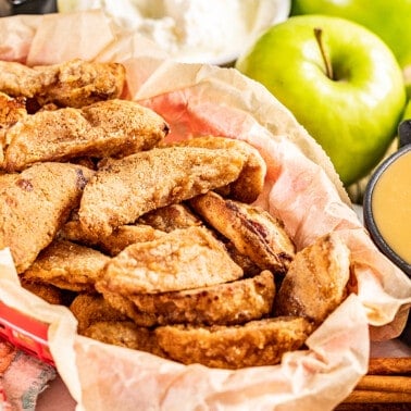 A basket of apple fries with a side of caramel.