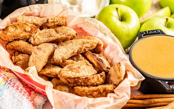 A basket of apple fries with a side of caramel.