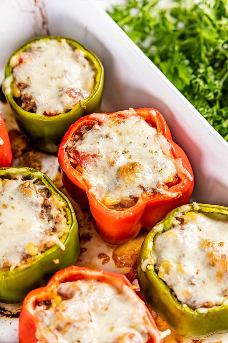 Stuffed bell peppers in a baking dish.