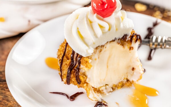 Close up view of fried ice cream with a bite removed.