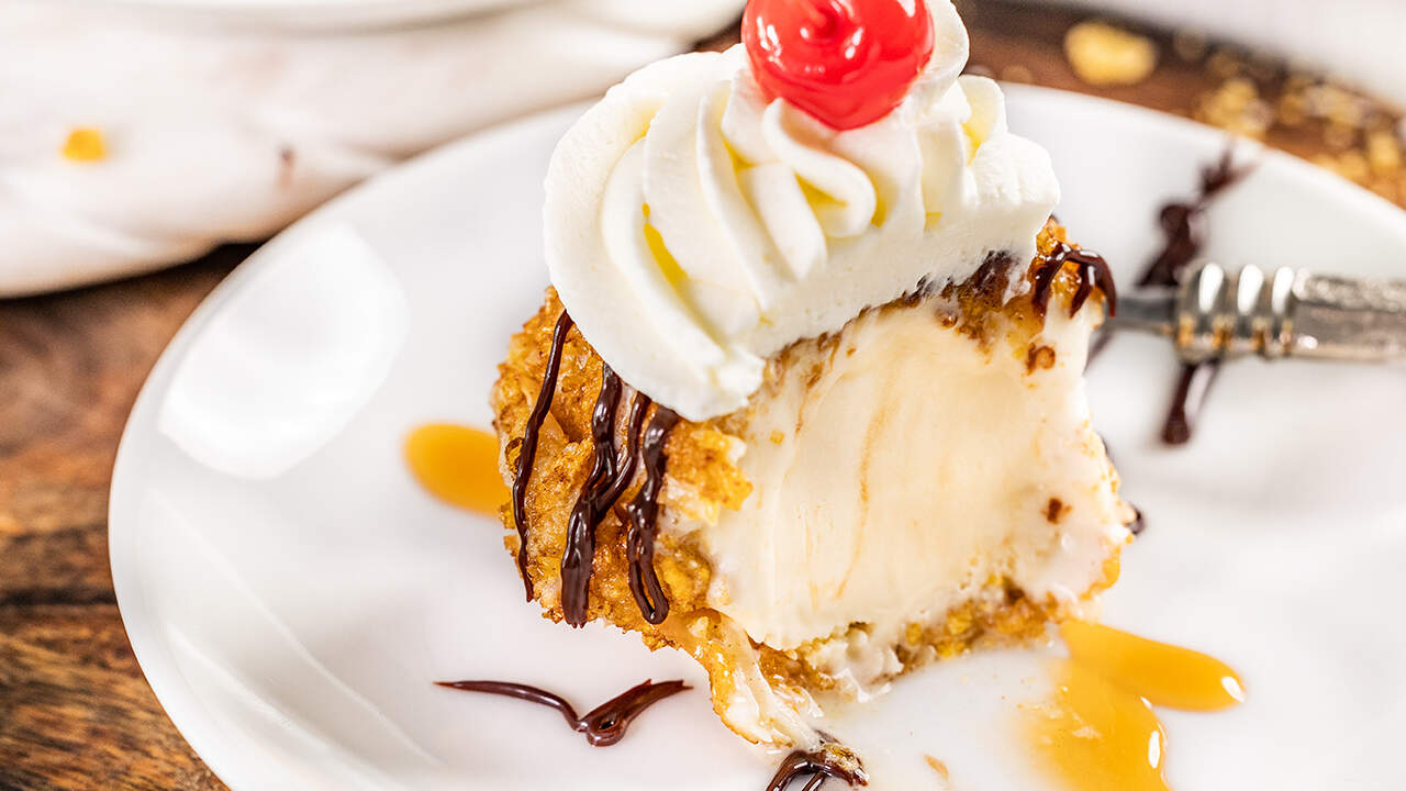 Close up view of fried ice cream with a bite removed.