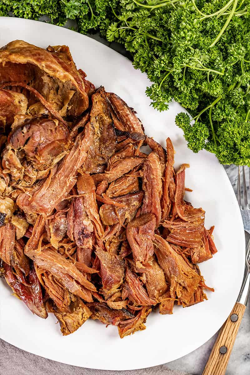 Overhead view of savory pulled ham on a serving platter.