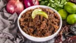 Close up view of a bowl filled with Mexican beef Barbacoa.