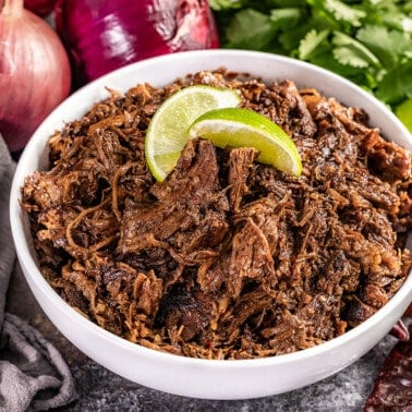 Close up view of a bowl filled with Mexican beef Barbacoa.
