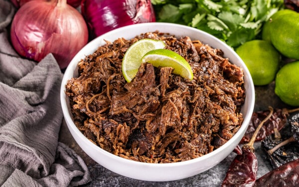Close up view of a bowl filled with Mexican beef Barbacoa.