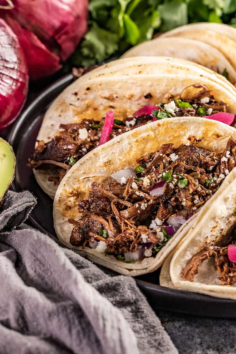 Close up view of tacos filled with Mexican beef Barbacoa.