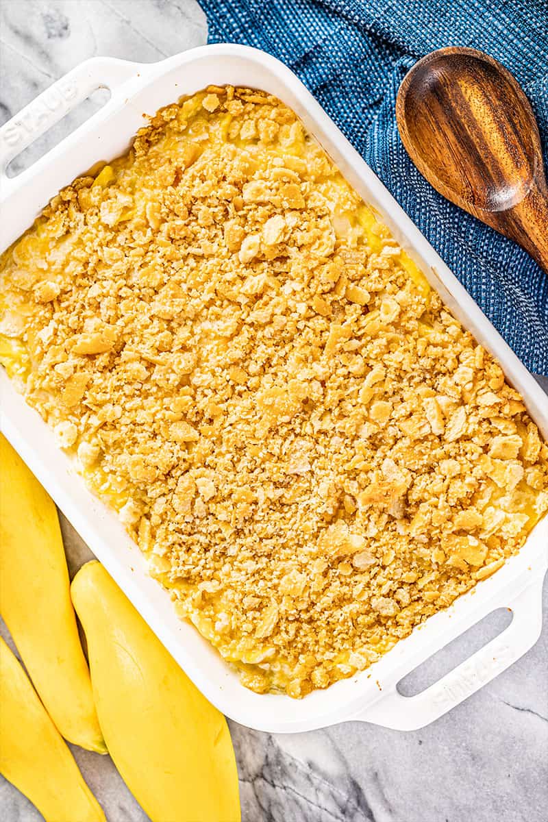 Overhead view of a squash casserole in a white baking dish.