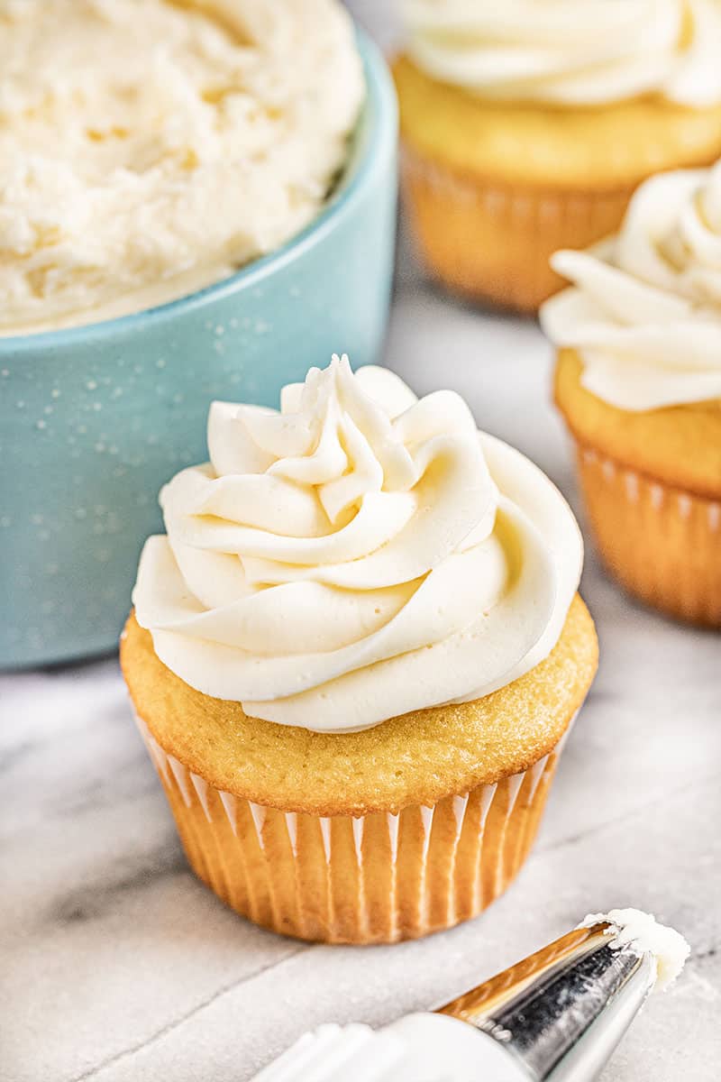 Close up view of a cupcake with buttercream frosting.