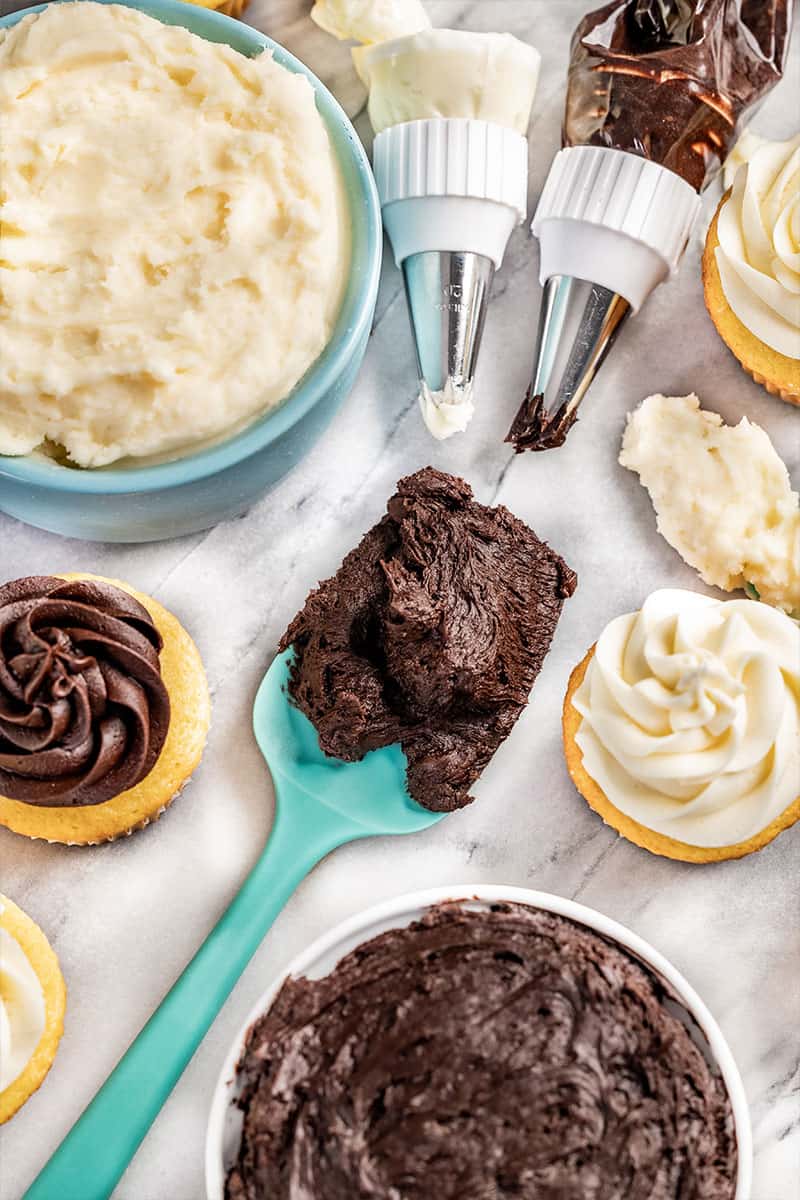 Overhead view of buttercream frosting in bowls.