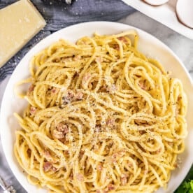 An overhead view of a plate of pasta carbonara.