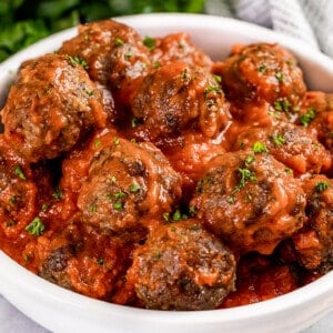 Close up view of baked meatballs in a serving bowl.