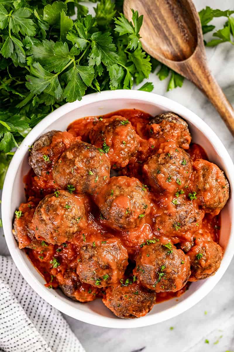 Overhead view of baked meatballs in a bowl.