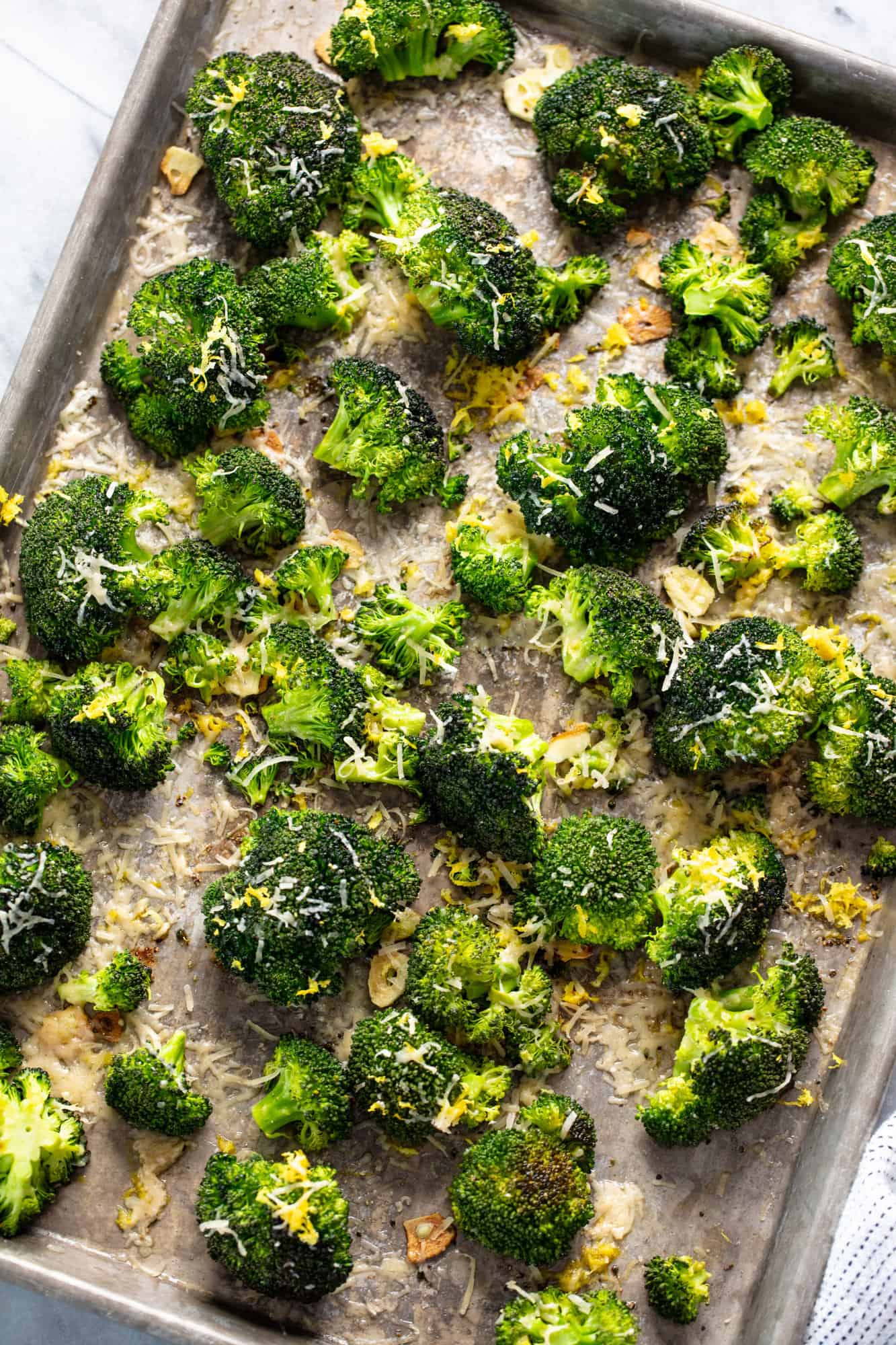 Overhead view of broccoli on a baking sheet.