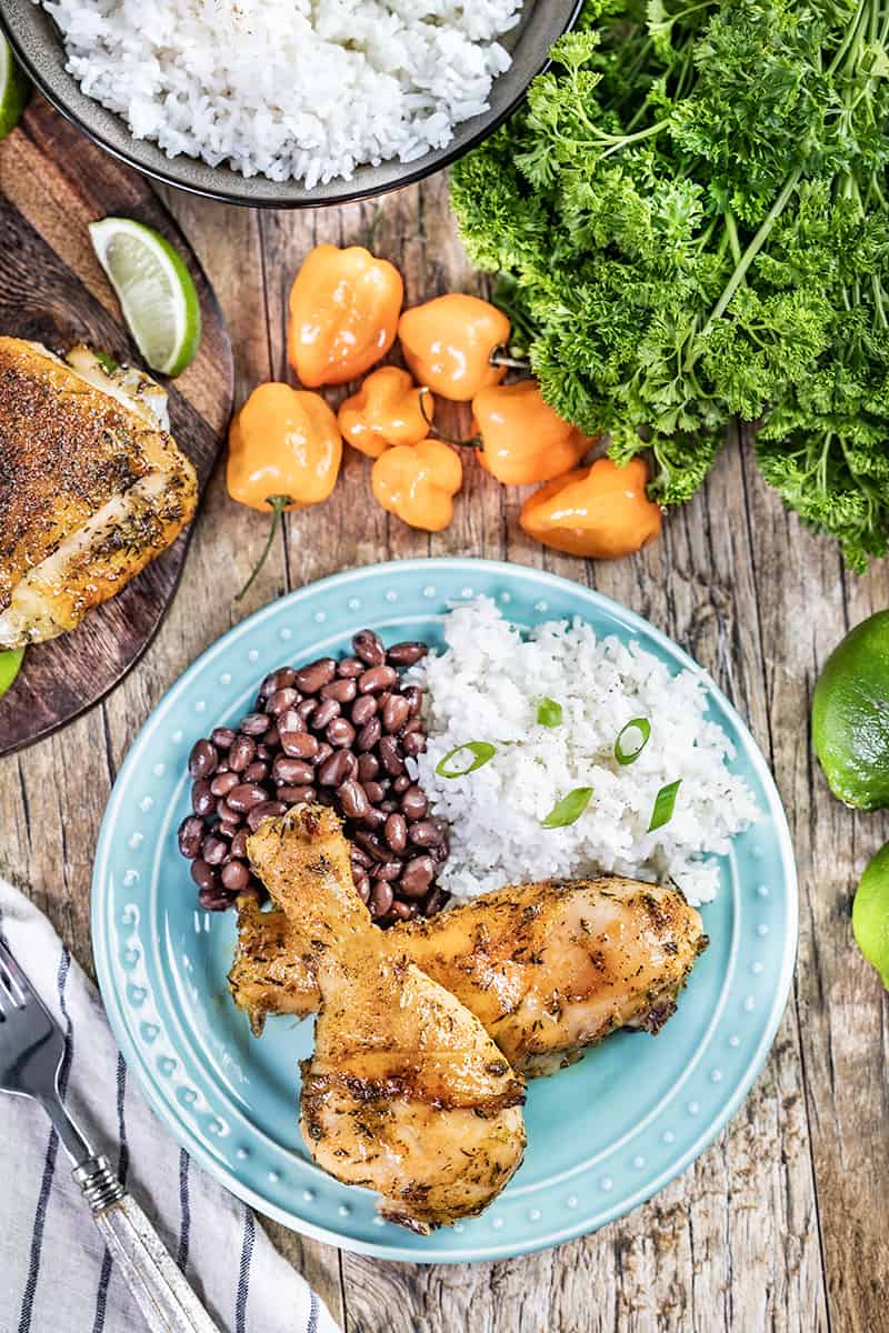 Overhead view of oven roasted jerk chicken on a dinner plate.