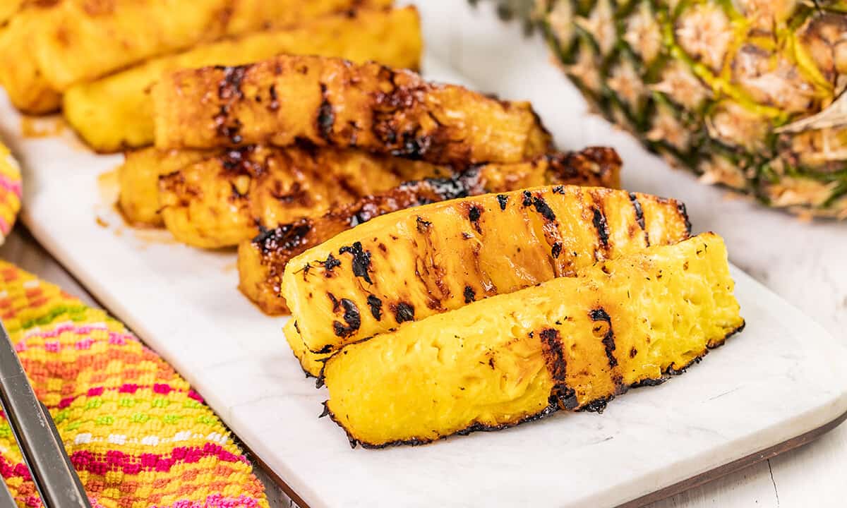 Grilled pineapple spears on a serving platter.