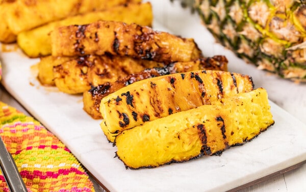 Grilled pineapple spears on a serving platter.