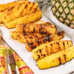 Grilled pineapple spears on a platter.