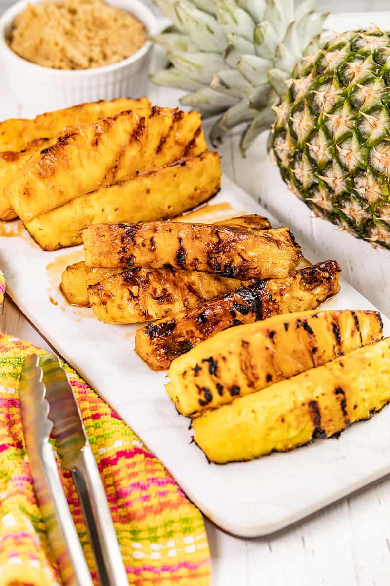 Grilled pineapple spears on a platter.