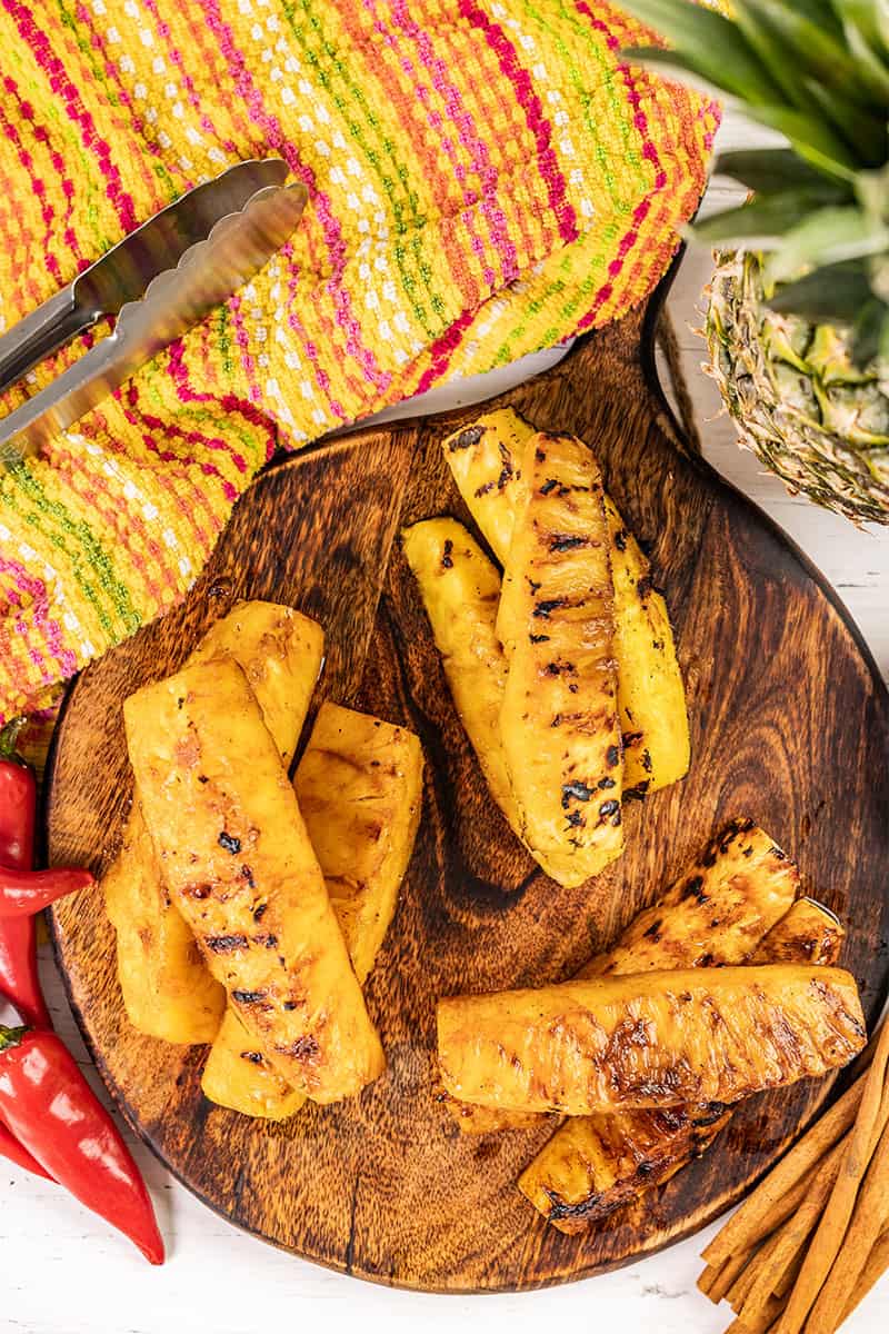 Overhead view of grilled pineapple spears on a platter.