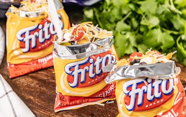 Individual small bags of Fritos full of crispy frito pie.