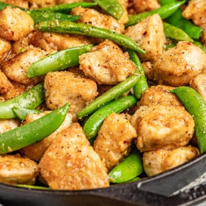 Close up view of honey garlic chicken and snap peas.