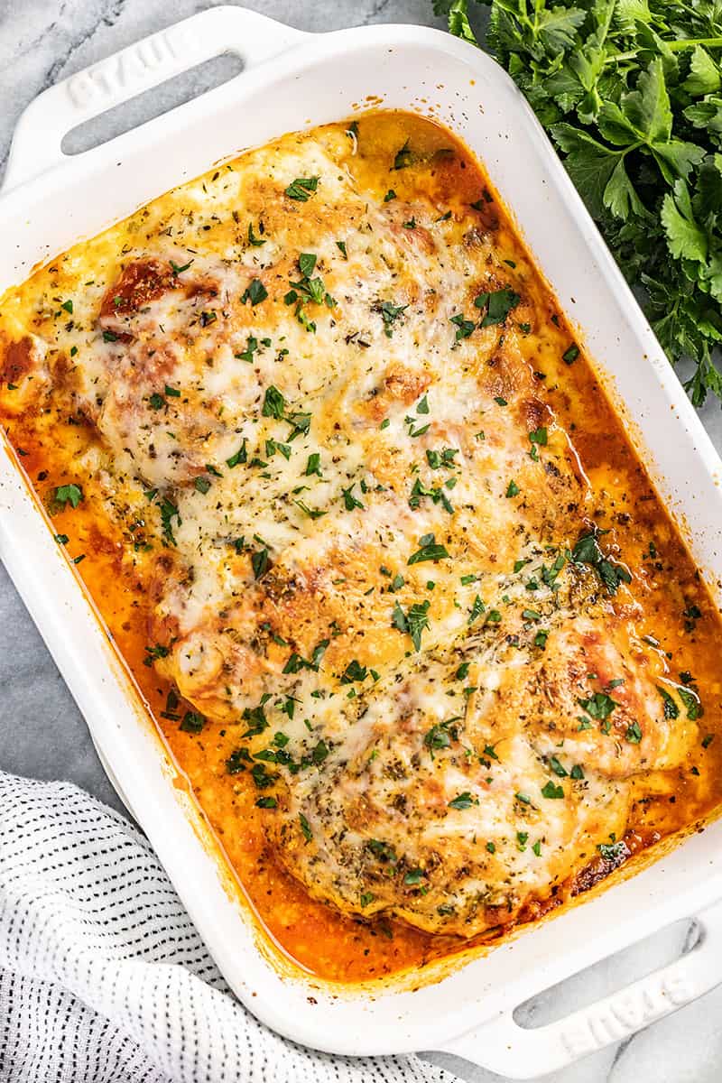 Overhead view of a casserole dish filled with lasagna stuffed chicken breasts.