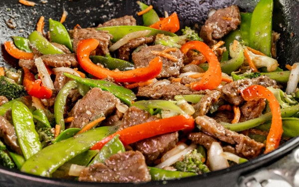 Close up view of takeout beef stir fry in a wok.