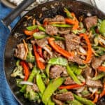 Overhead view of takeout beef stir fry in a wok.