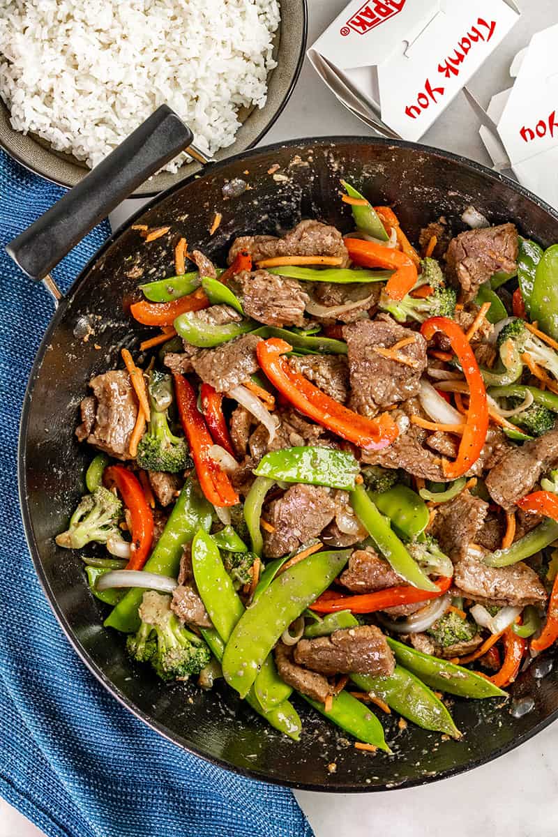 Overhead view of takeout beef stir fry in a wok.