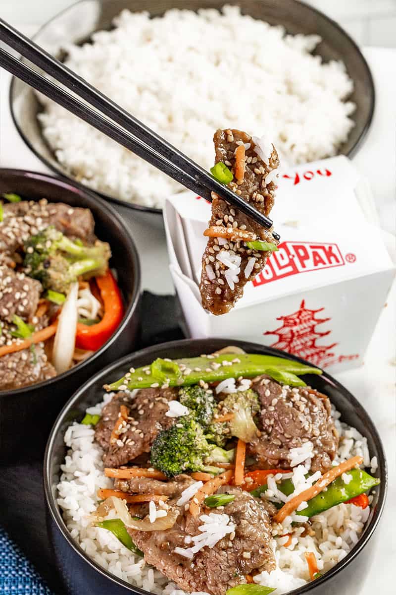 Takeout beef stir fry with chopsticks.