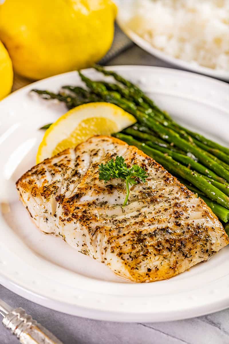 Pan seared fish on a plate.