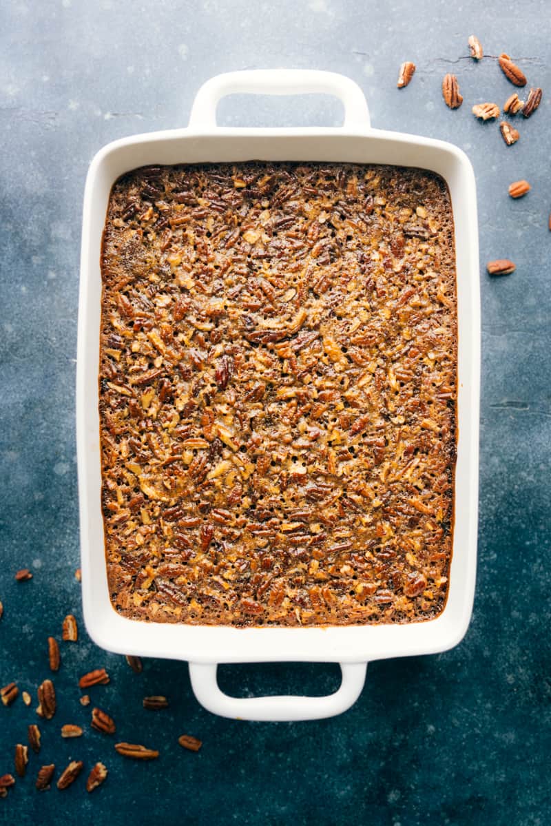 Uncut Pecan Bars in a white 9-inch by 13-inch pan with handles.