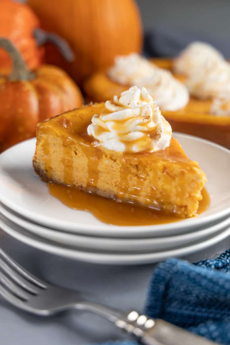 A slice of pumpkin cheesecake on a plate. 