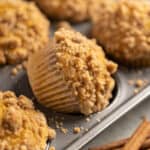 Muffin tin filled with pumpkin muffins.