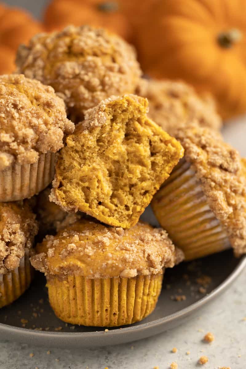 Pumpkin muffins with a bite taken out of one muffin.