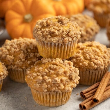 Pumpkin muffins stacked on top of each other.