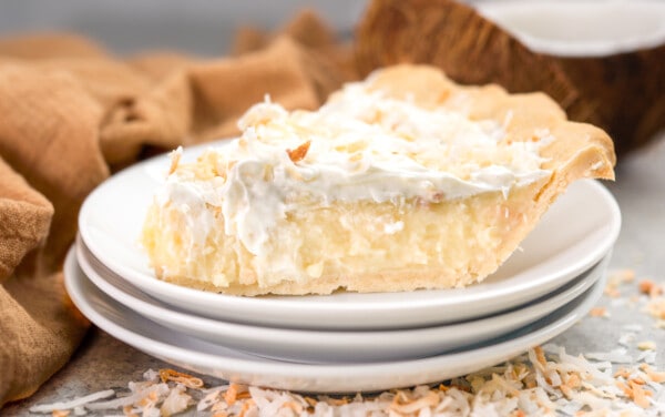 Close up view of a slice of coconut cream pie.