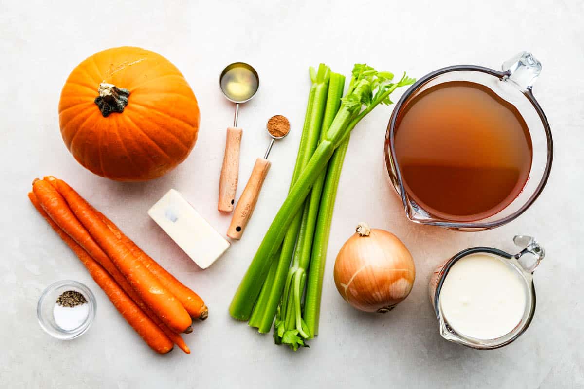 An overhead view of the ingredients needed to make pumpkin soup.