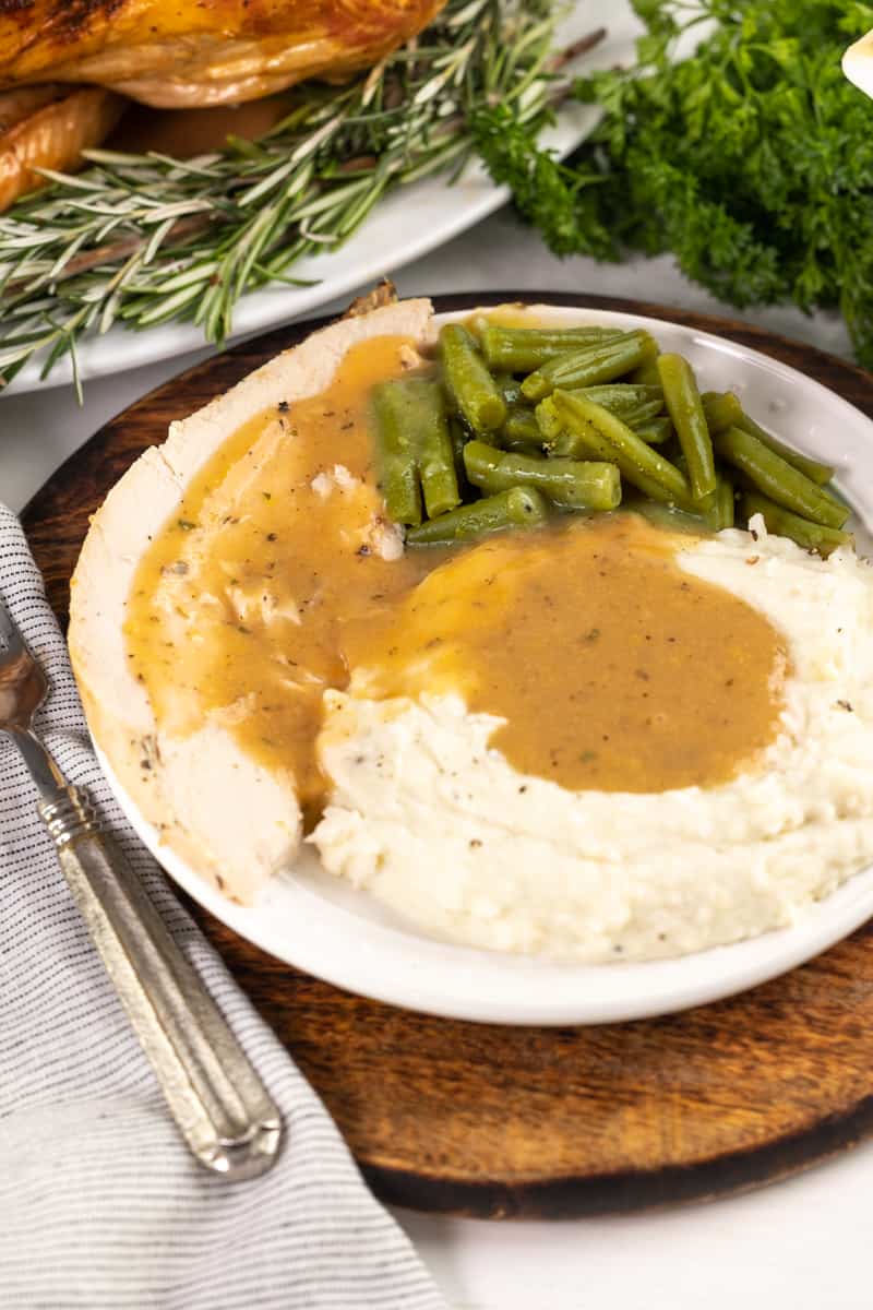 Turkey gravy on top of turkey and mashed potatoes.