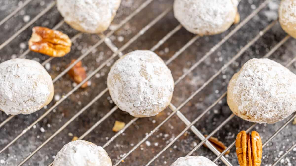 Overhead view of pecan sandies on a cooling rack.