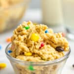 Edible M&M cookie dough in a small glass bowl.