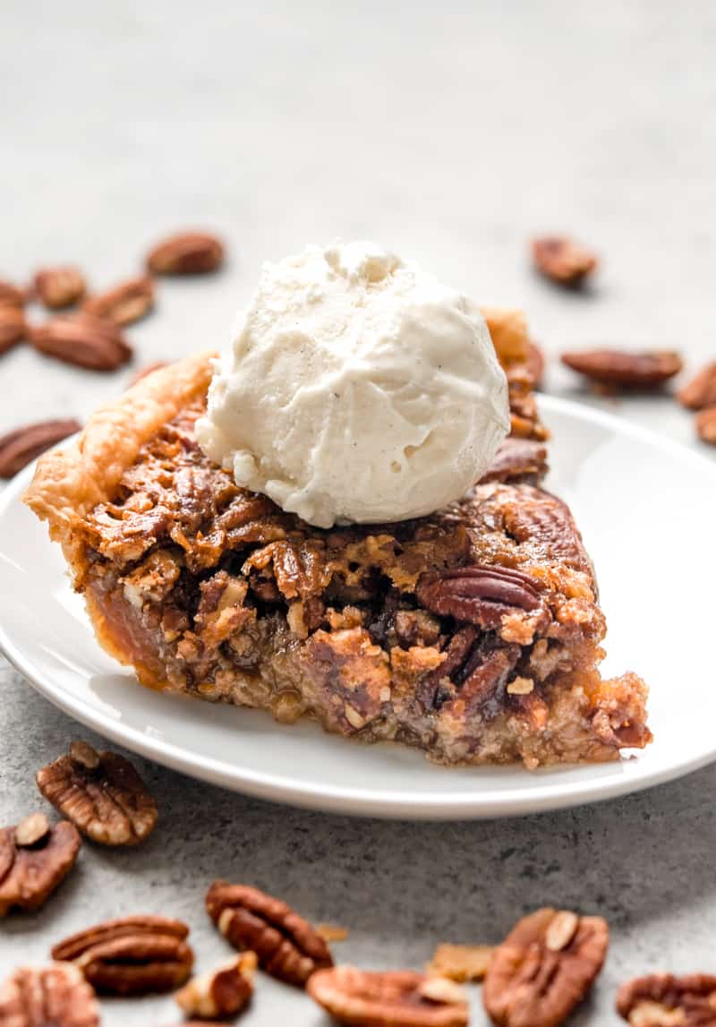 A slice of pecan pie with ice cream on top.