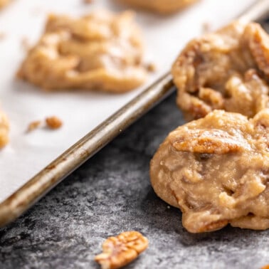 Pecan pralines on a cookie sheet.